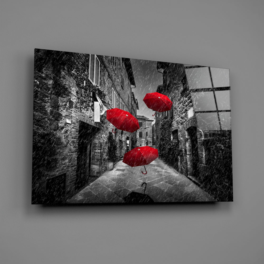 Close-up detail of floating red umbrellas above a gray European alley