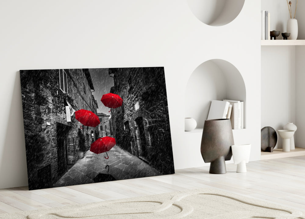 Red Umbrellas glass wall art styled above a sofa in a literary living room