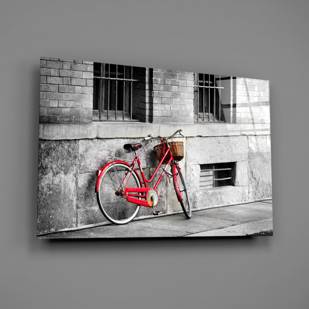 Close-up detail of the red bicycle leaning against a gray brick wall