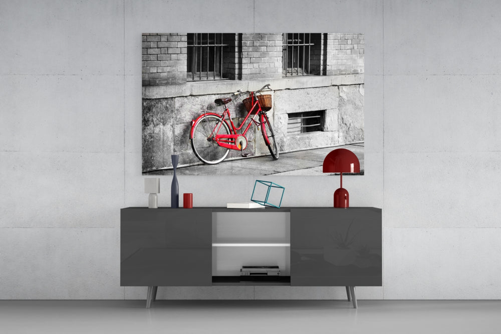 Fine art photography – charming red vintage bicycle with wicker basket leaning against weathered monochrome stone building wall