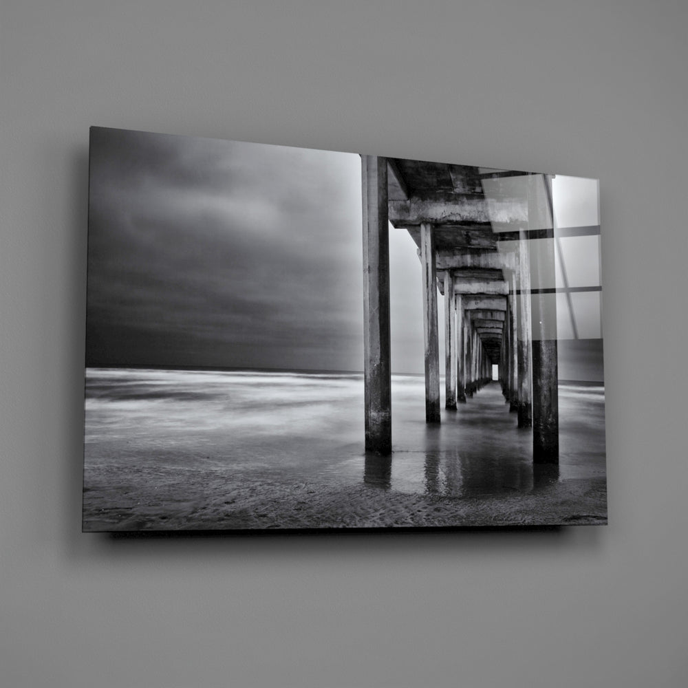Close-up detail of concrete pillars vanishing into long-exposure water
