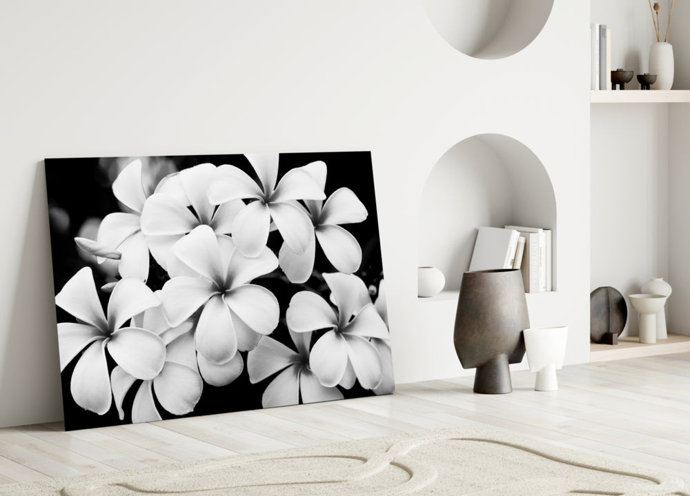 Flower glass wall art styled above a bed in a modern, refined bedroom