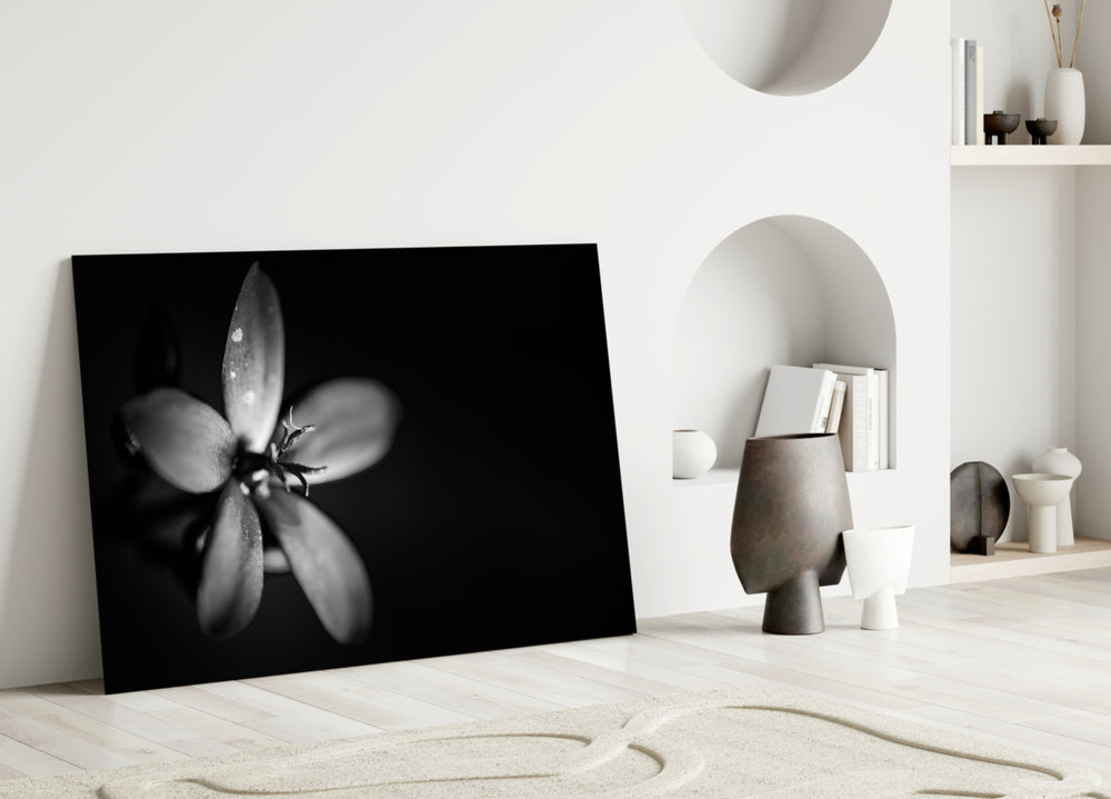 Flower glass wall art styled above a bed in a modern, refined bedroom