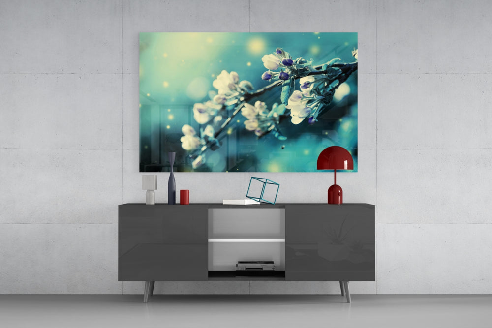 Fine art macro photography – delicate cherry blossom branch with white blooms, turquoise-teal color tone and sparkling bokeh light particles