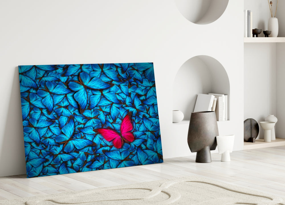 Butterfly glass wall art styled above a bed in a reflective bedroom