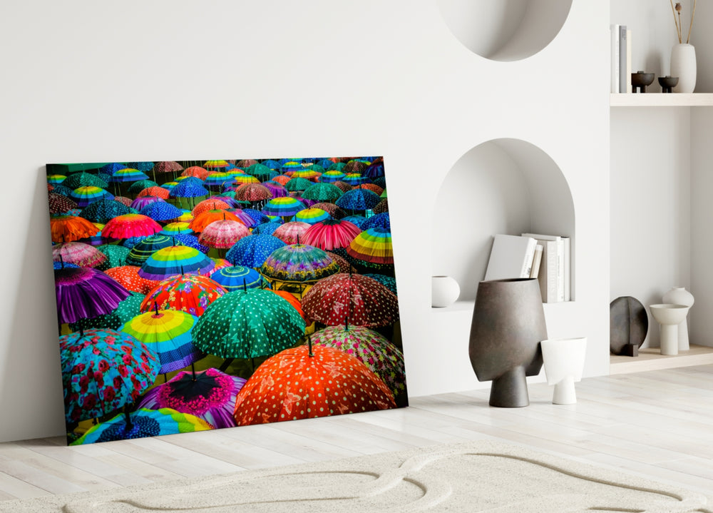 Colorful Umbrellas glass wall art styled above a sofa in a playful living room