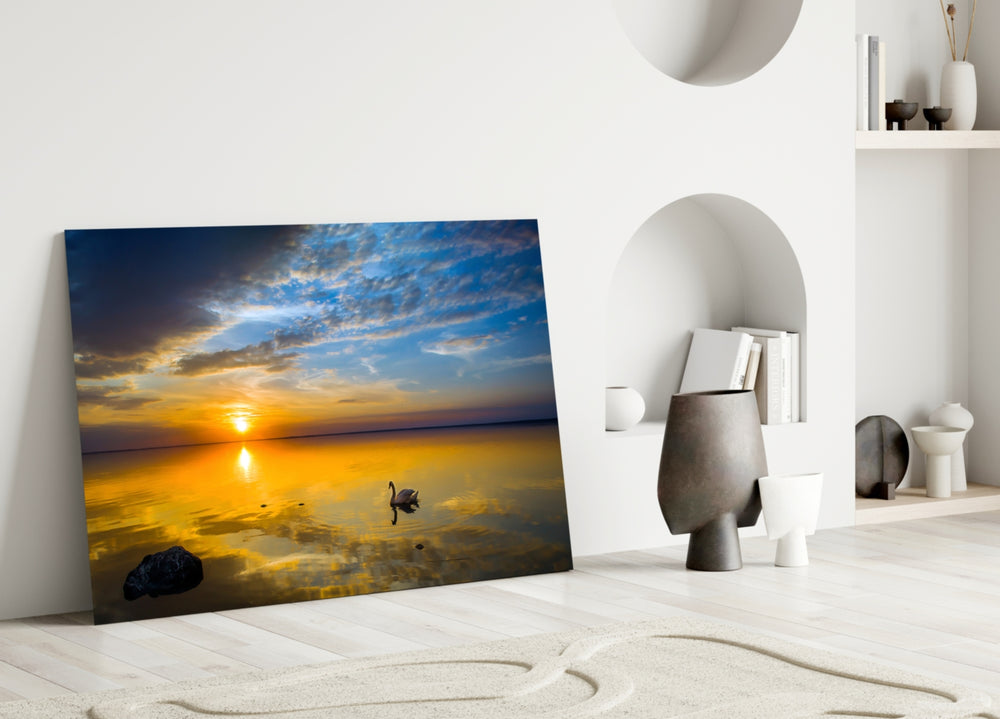 Swan glass wall art styled above a bed in a tranquil bedroom