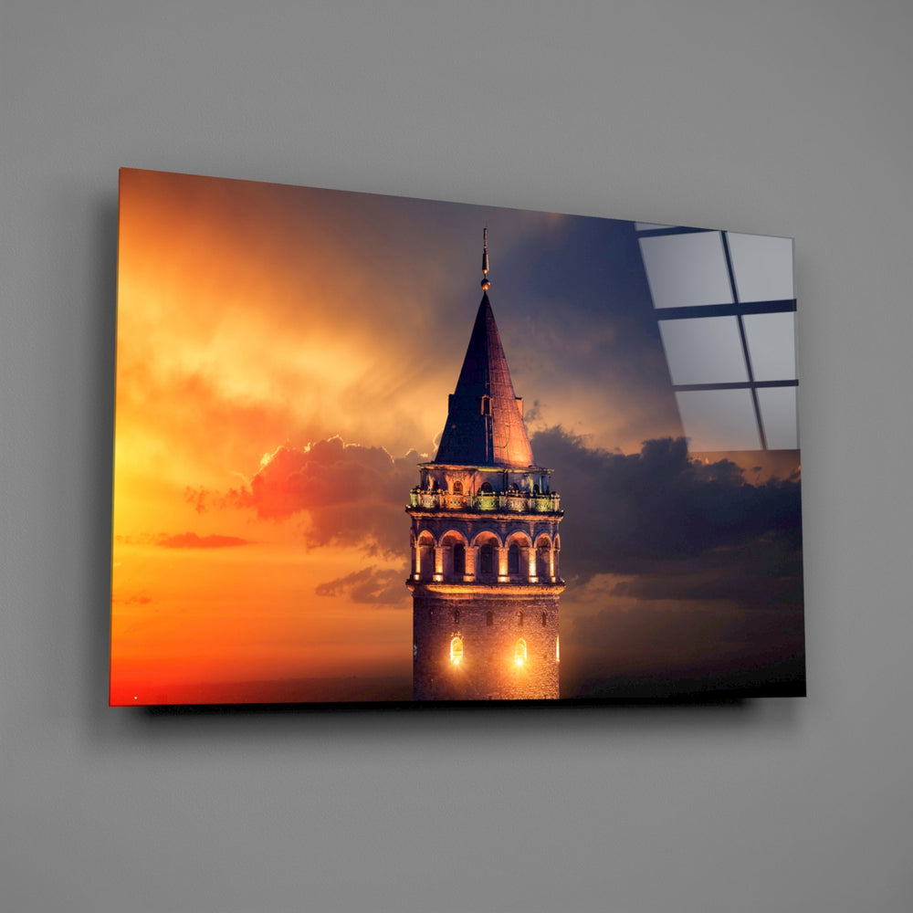 Close-up detail of the Galata Tower silhouette against amber sky