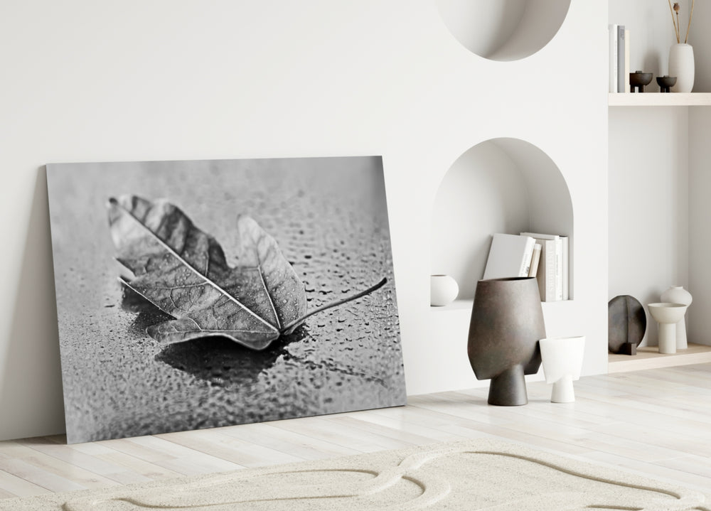 Leaf glass wall art styled above a bed in a modern, restrained bedroom