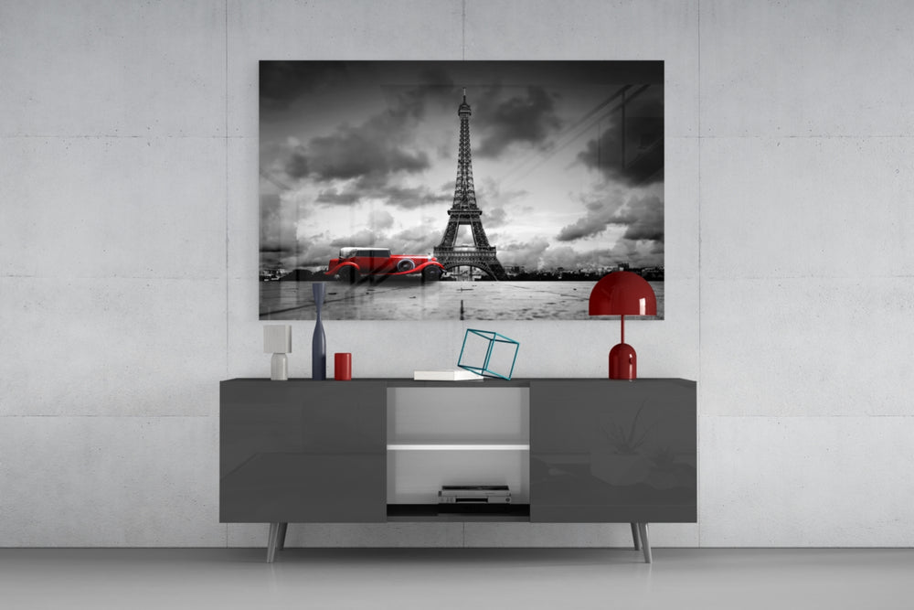 Fine art photography – elegant red vintage automobile parked in front of towering Eiffel Tower, monochrome scene with selective crimson color