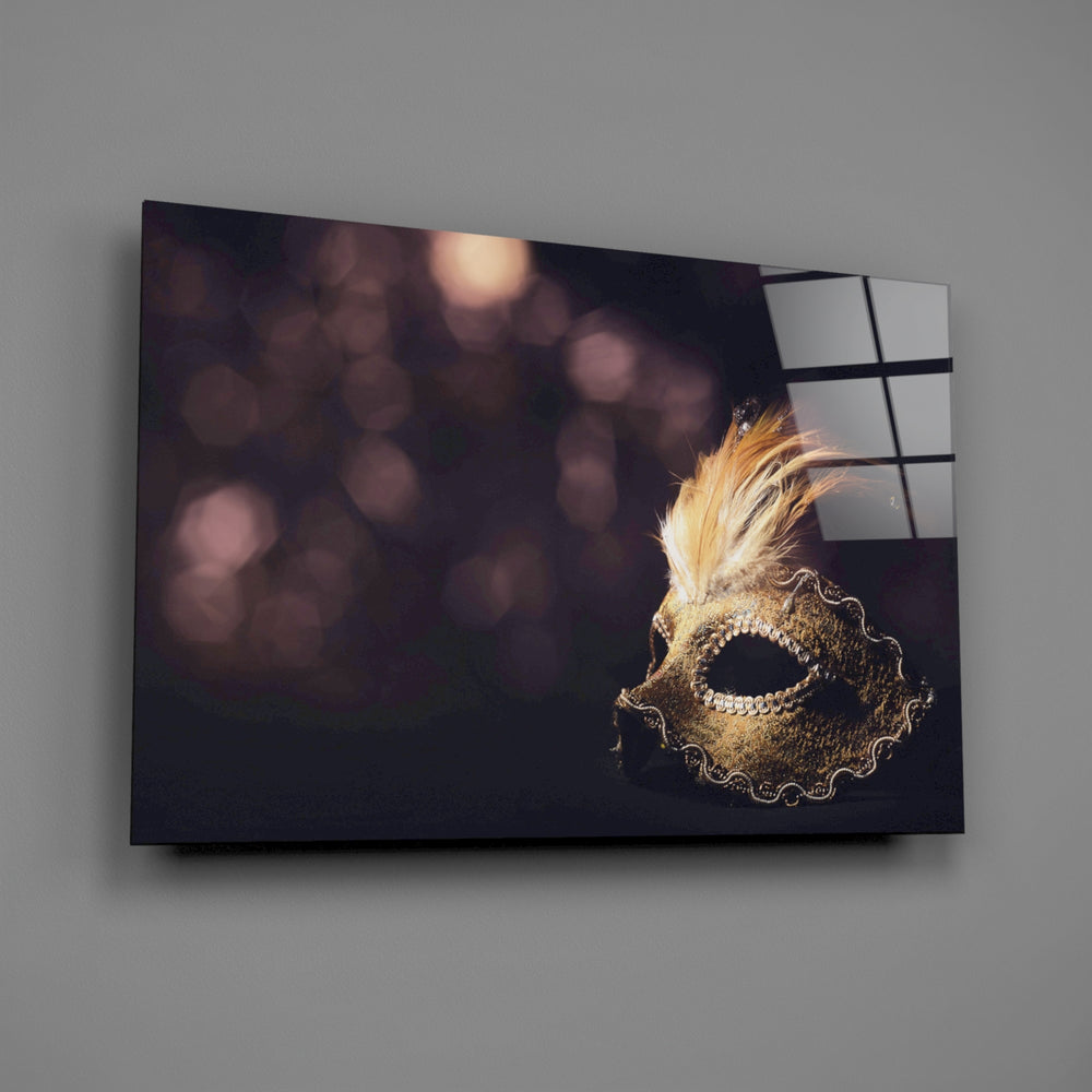 Close-up detail of the gold feathered Venetian mask in warm bokeh