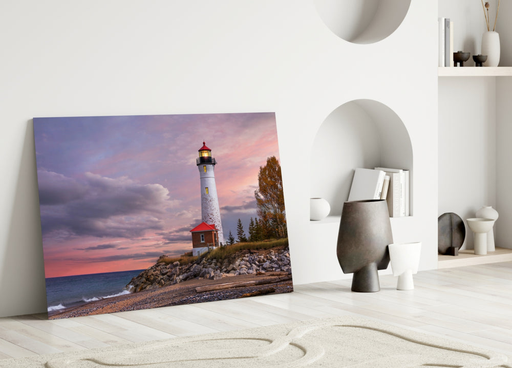 Lighthouse glass wall art styled above a bed in a coastal-inspired bedroom
