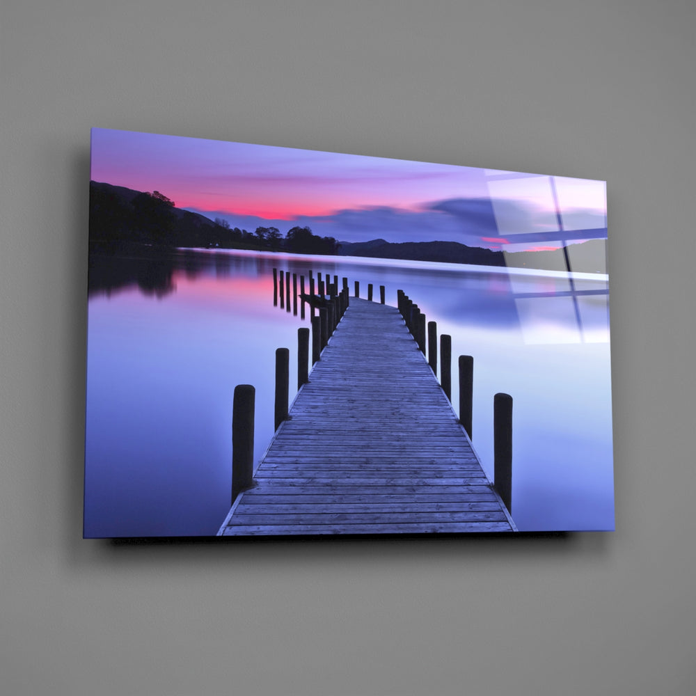 Close-up detail of the dock extending into a rose-and-indigo lake