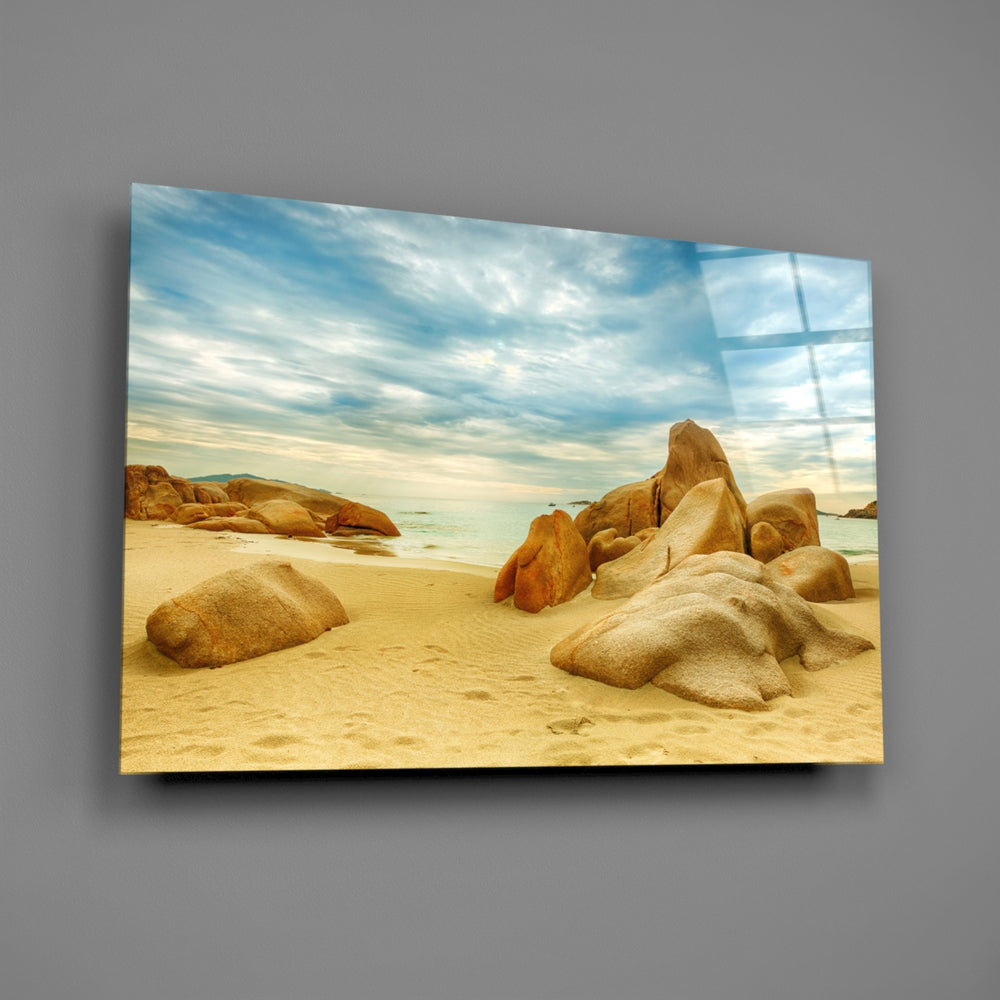 Close-up detail of golden boulders and turquoise surf on the beach