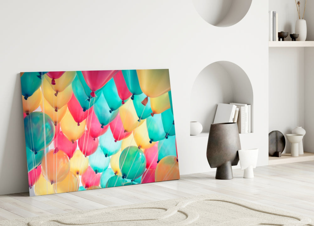 Balloons glass wall art styled above a bed in a kid's or nursery room
