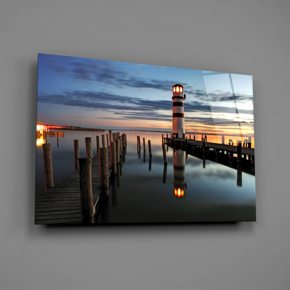 Close-up detail of the striped lighthouse reflected in still water