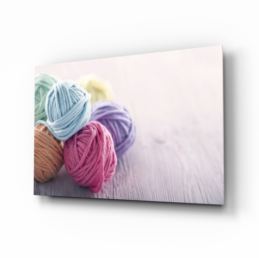 Pastel yarn still-life panel bringing craft warmth to a contemporary living space