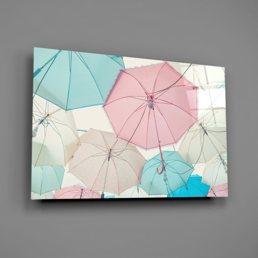 Close-up detail of pastel rose, mint, and sky-blue umbrellas from below