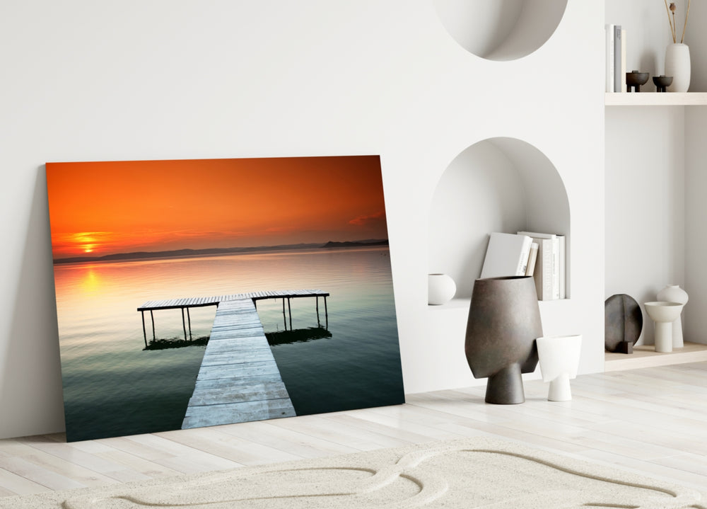 Close-up detail of the T-shaped dock against orange sunset water