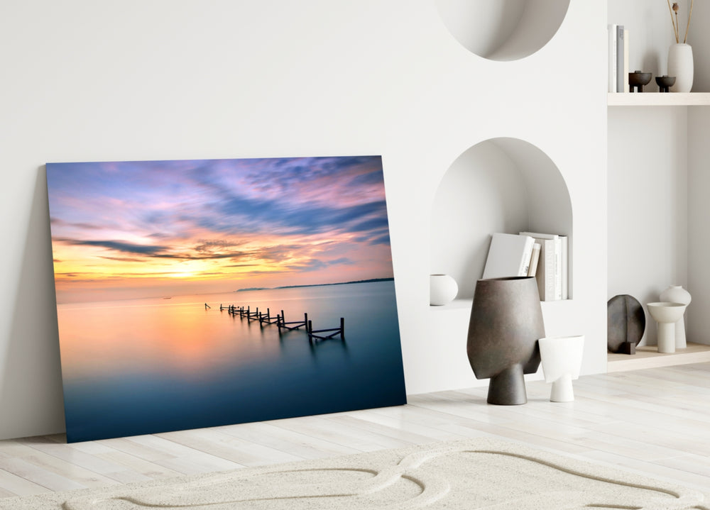 Close-up detail of the weathered pier posts against pastel sunset water