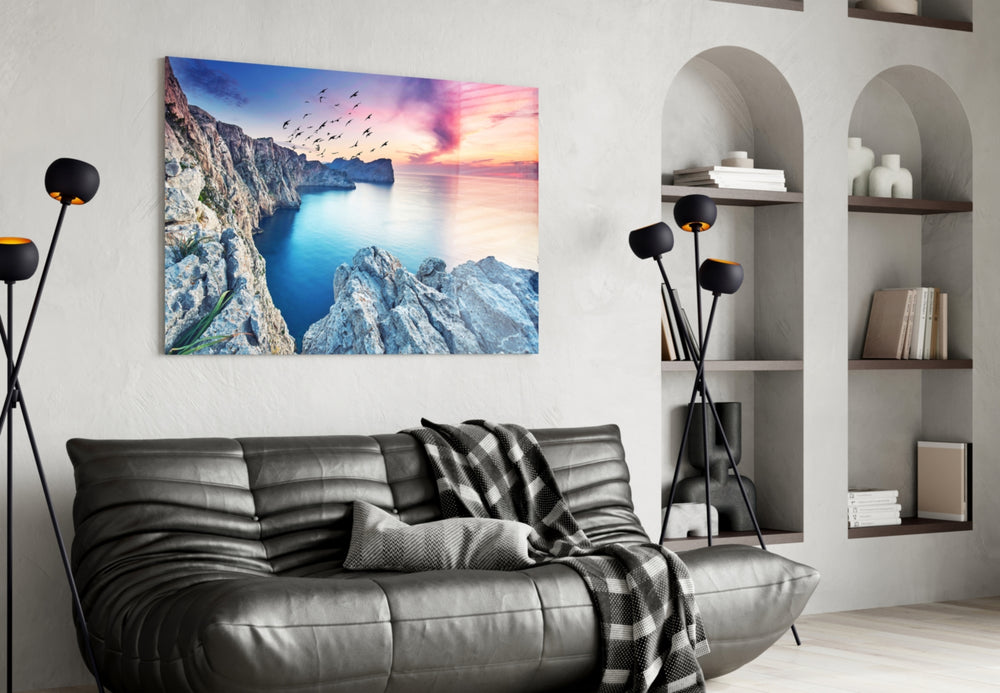 Red Sunset glass wall art styled above a sofa in a travel-inspired living room