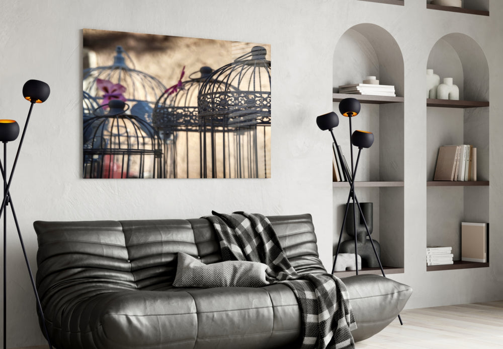 Birdcage glass wall art styled above a sofa in a literary-mood reading nook