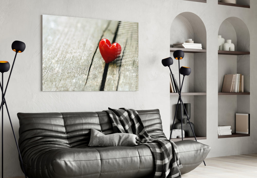 Heart glass wall art styled above a bed in a gentle-mood bedroom
