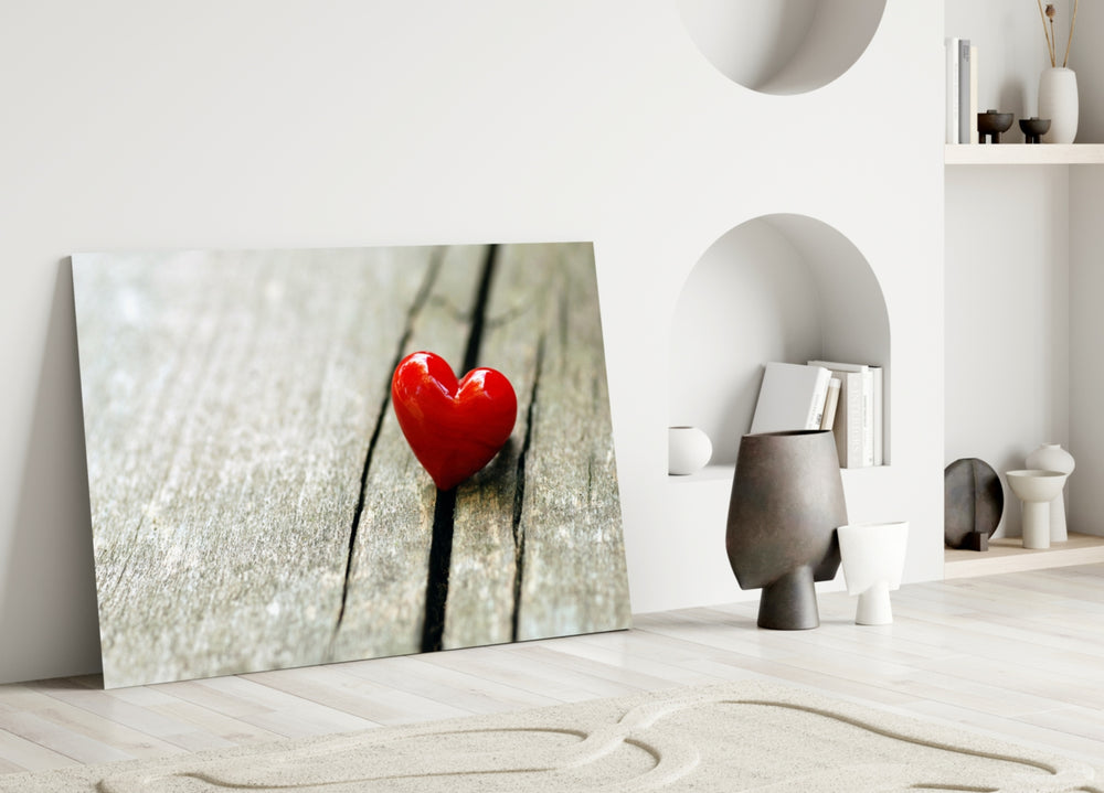 Close-up detail of the red ceramic heart on wood grain
