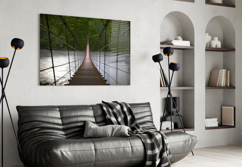 Suspension Bridge glass wall art styled above a sofa in a forest-mood living room