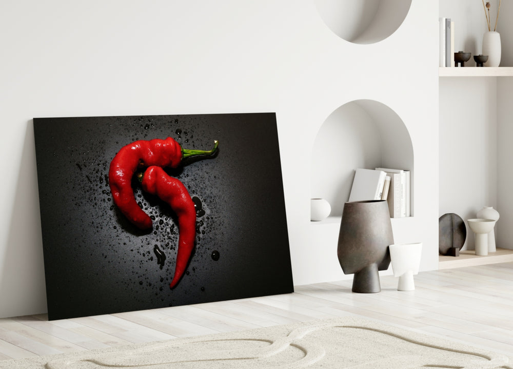 Close-up detail of the red chilies and water droplets on black
