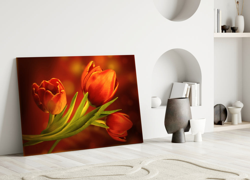 Close-up detail of the orange tulips against amber bokeh