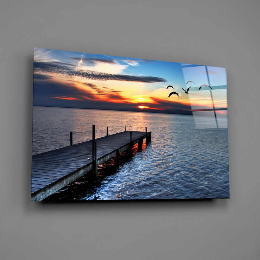 Fiery sunset pier panel bringing dramatic warmth to a contemporary living space