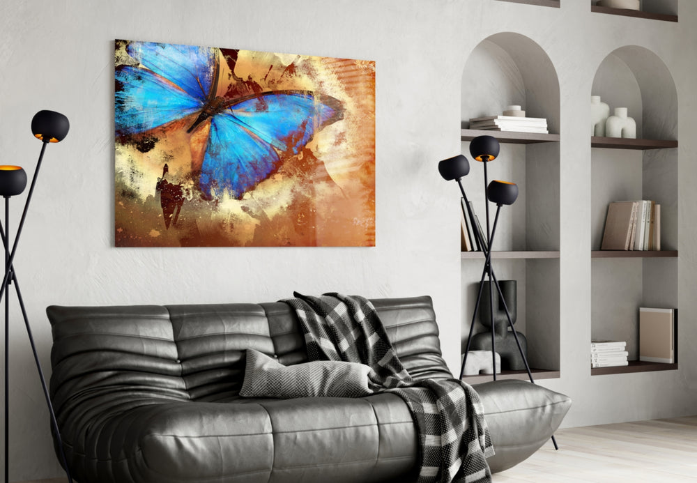 Butterfly glass wall art styled above a sofa in an autumn-warm living room