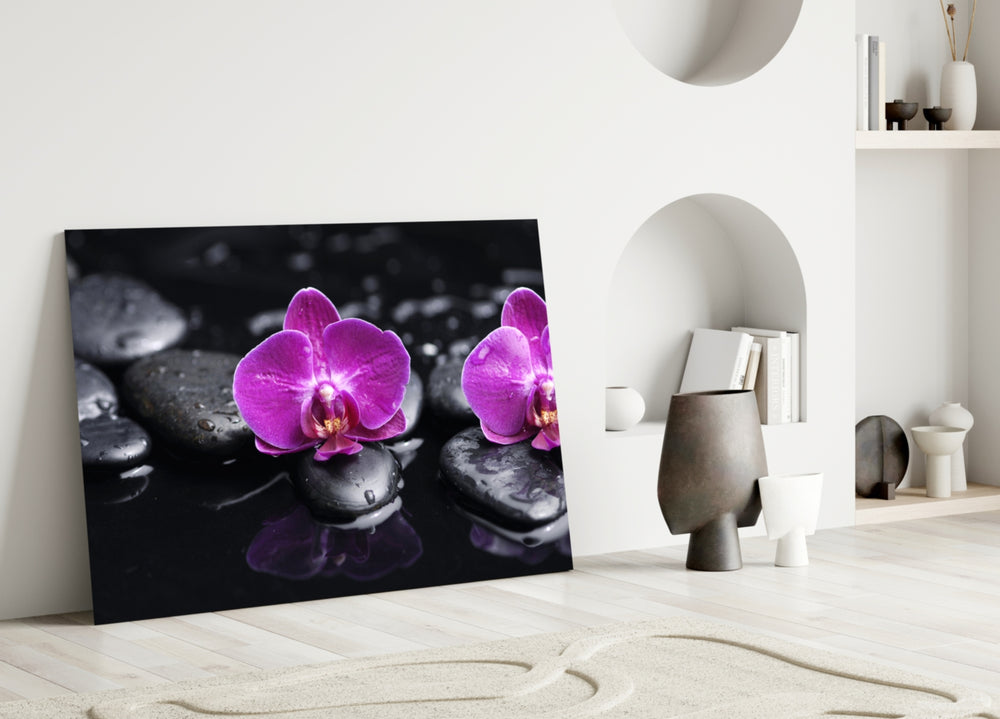 Close-up detail of the magenta orchids and water reflections