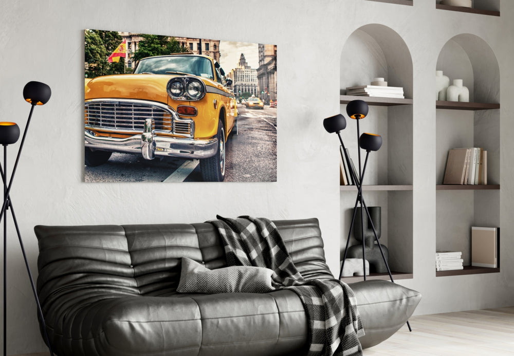 Classic Taxi glass wall art styled above a sofa in a global-city living room