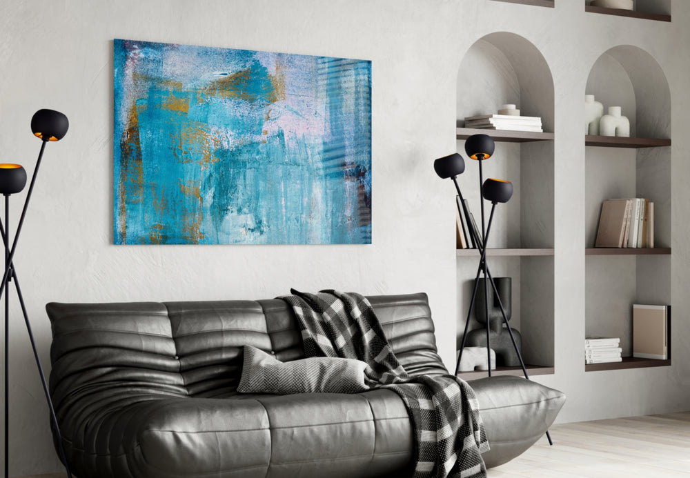 Blue glass wall art styled above a sofa in a coastal-luxe living room