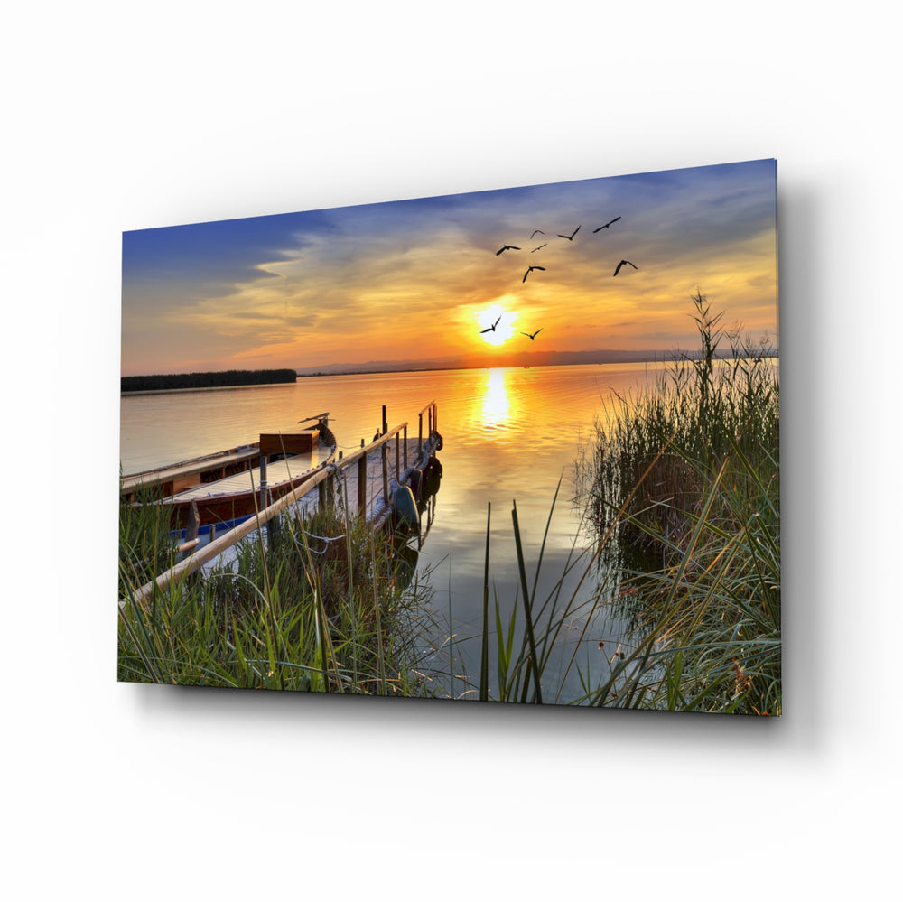 Sunset glass wall art displayed above a console in a designer interior
