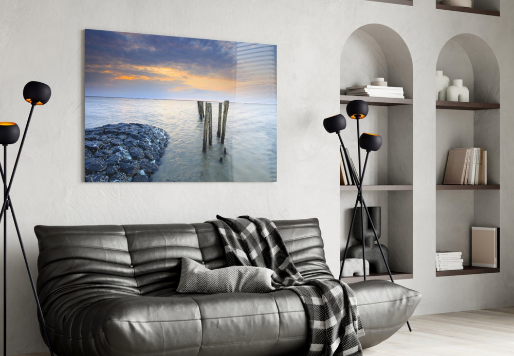 Sunset glass wall art styled above a bed in a seaside-mood bedroom