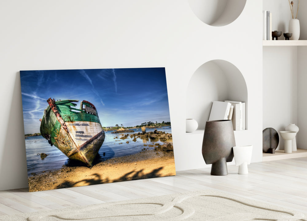 Close-up detail of the green-and-white fishing boat on sand