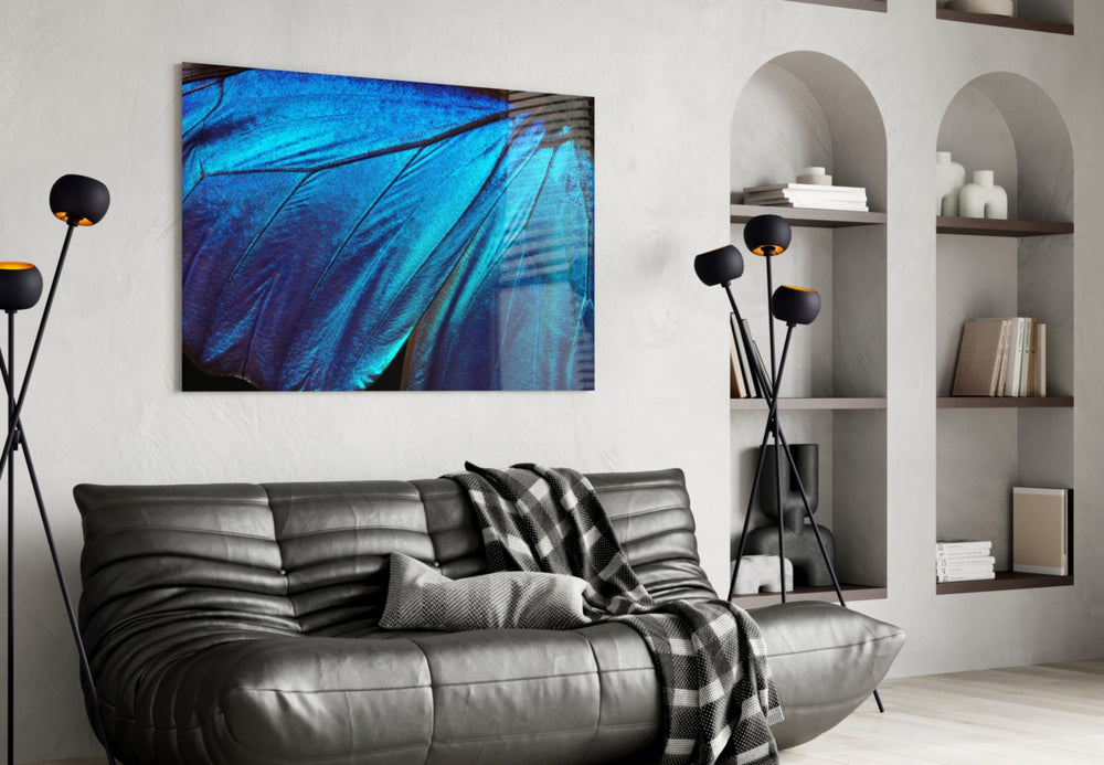 Butterfly Wing glass wall art styled above a bed in an electric-blue bedroom