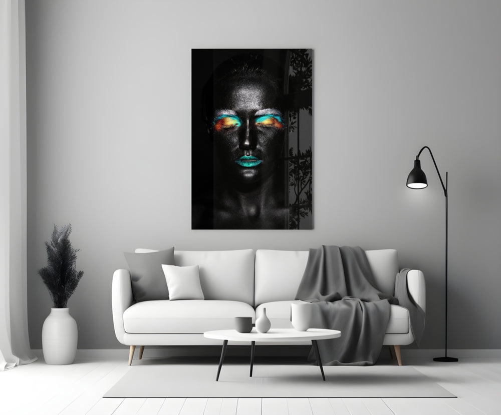 Close-up detail of turquoise lips and silver dust across matte black skin