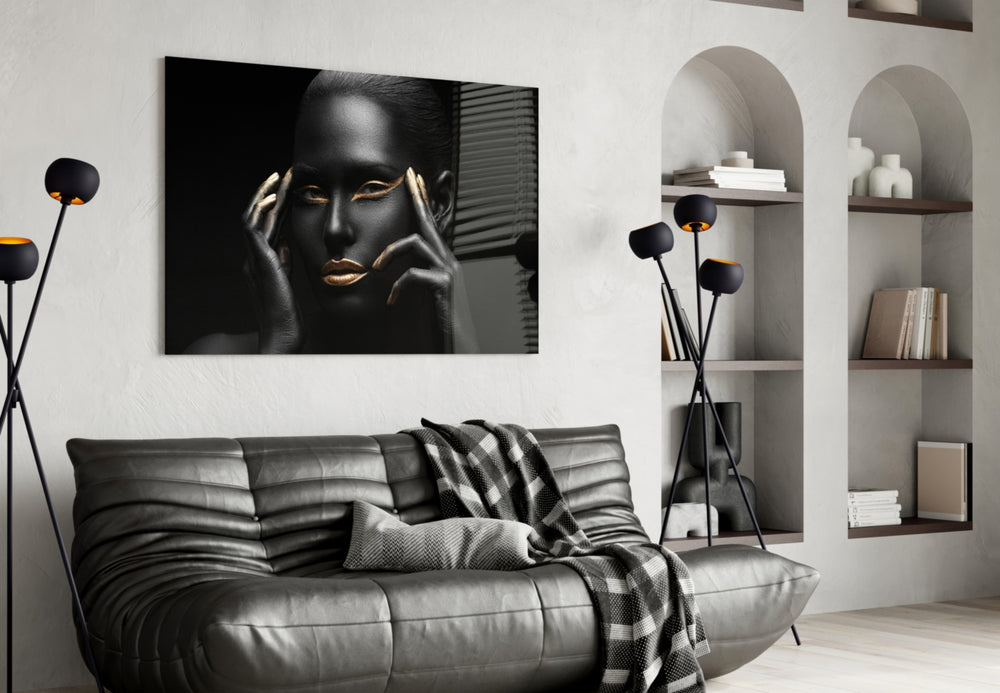 Woman glass wall art styled above a bed in an editorial bedroom