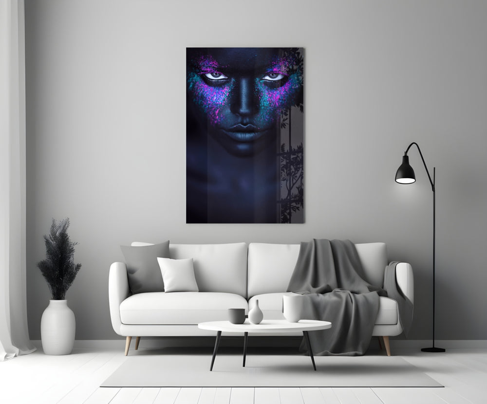 Woman glass wall art styled above a bed in a moody-color bedroom