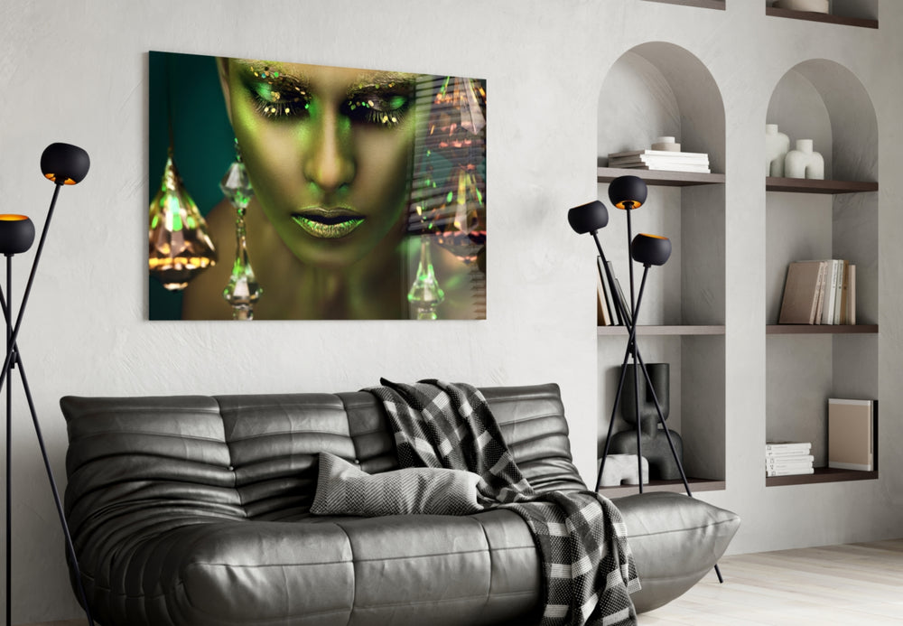 Woman glass wall art styled above a bed in a green-and-gold bedroom