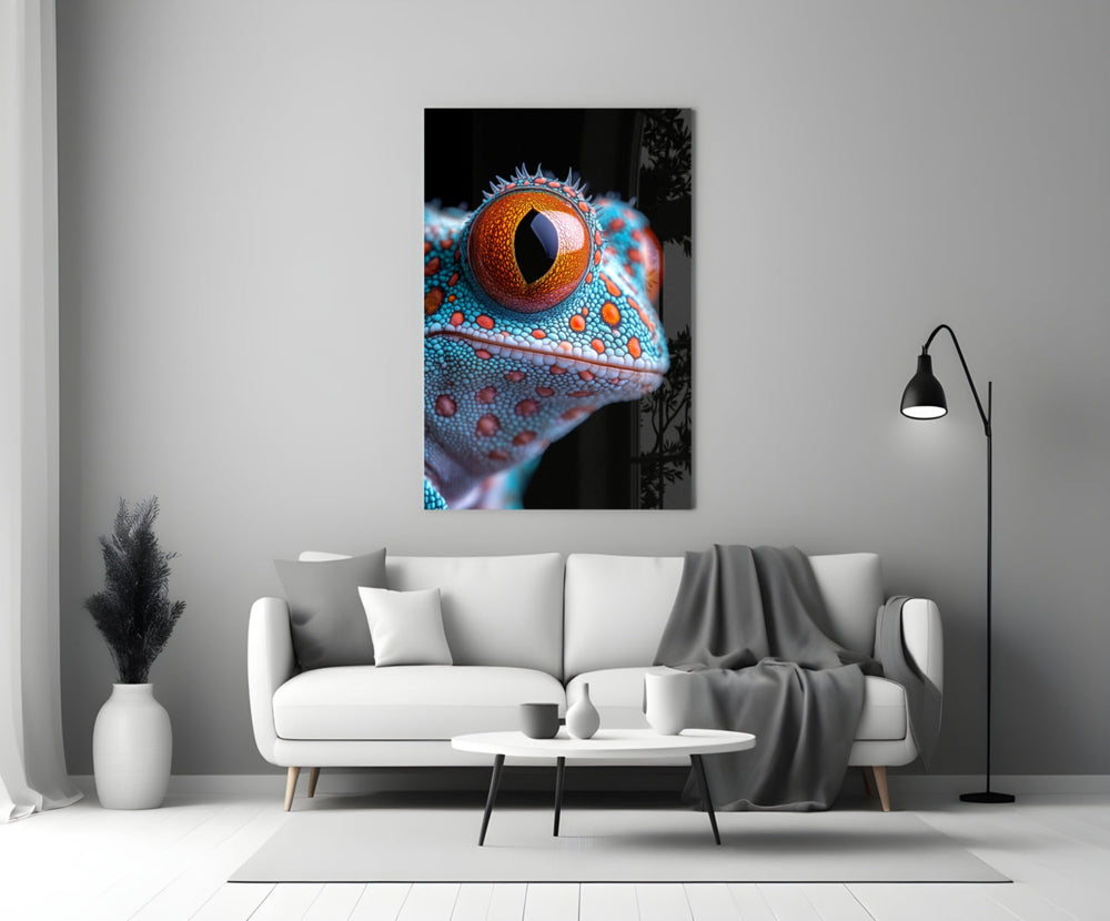 Close-up detail of turquoise gecko with marigold eye behind glass