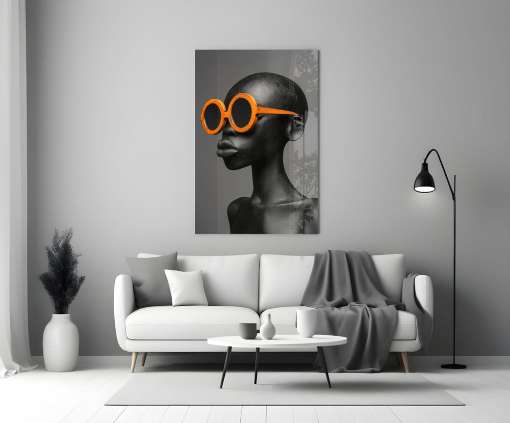 Close-up detail of bald female bust with tangerine sunglasses behind glass