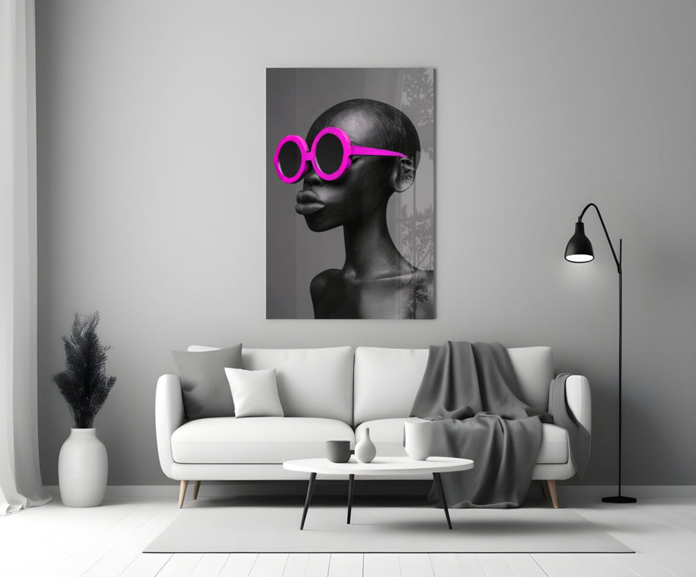 Close-up detail of bald female bust with magenta sunglasses behind glass