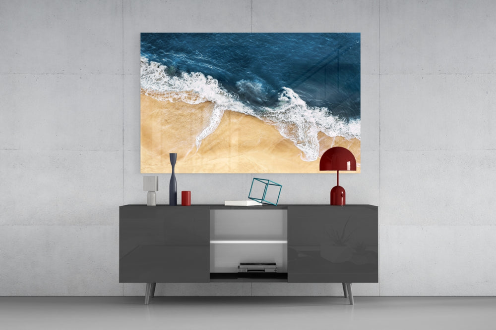 Sand-and-surf aerial glass wall art in light-filled garden room