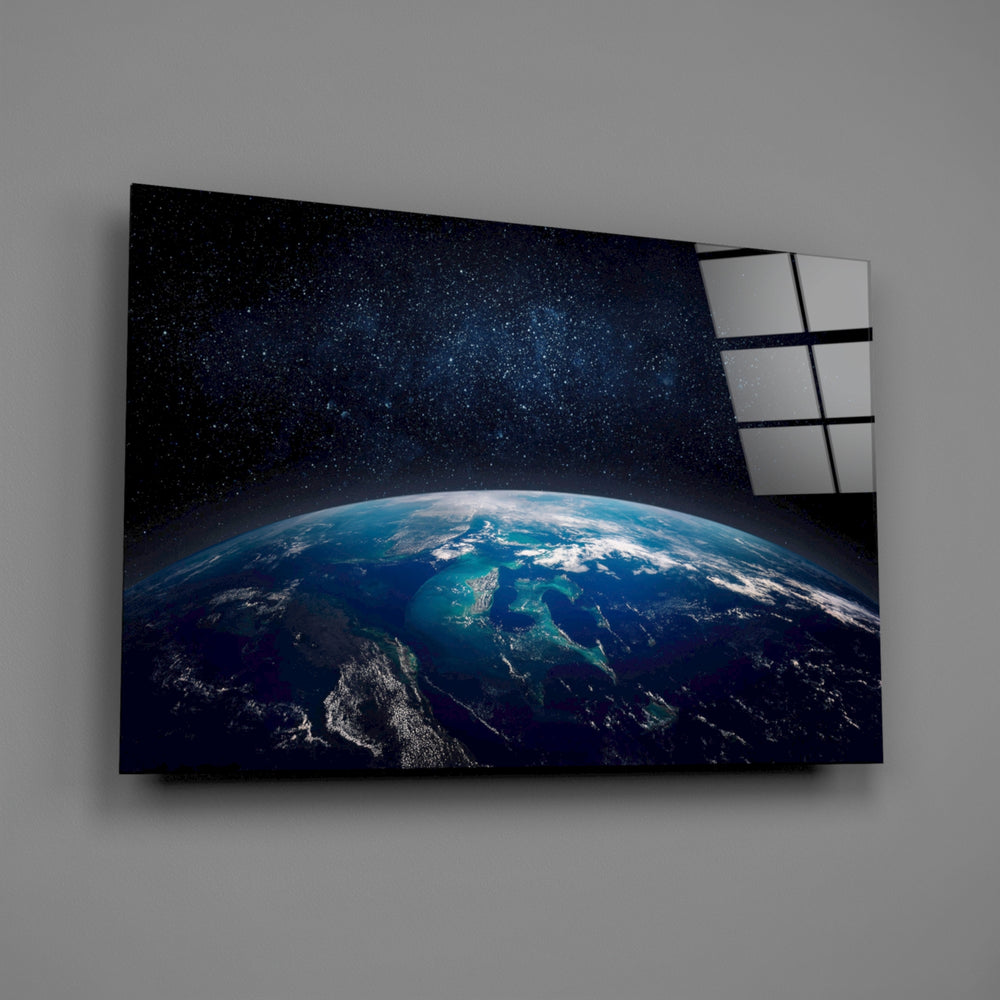 ISS-style Earth photography glass wall art over walnut console in tech-firm office