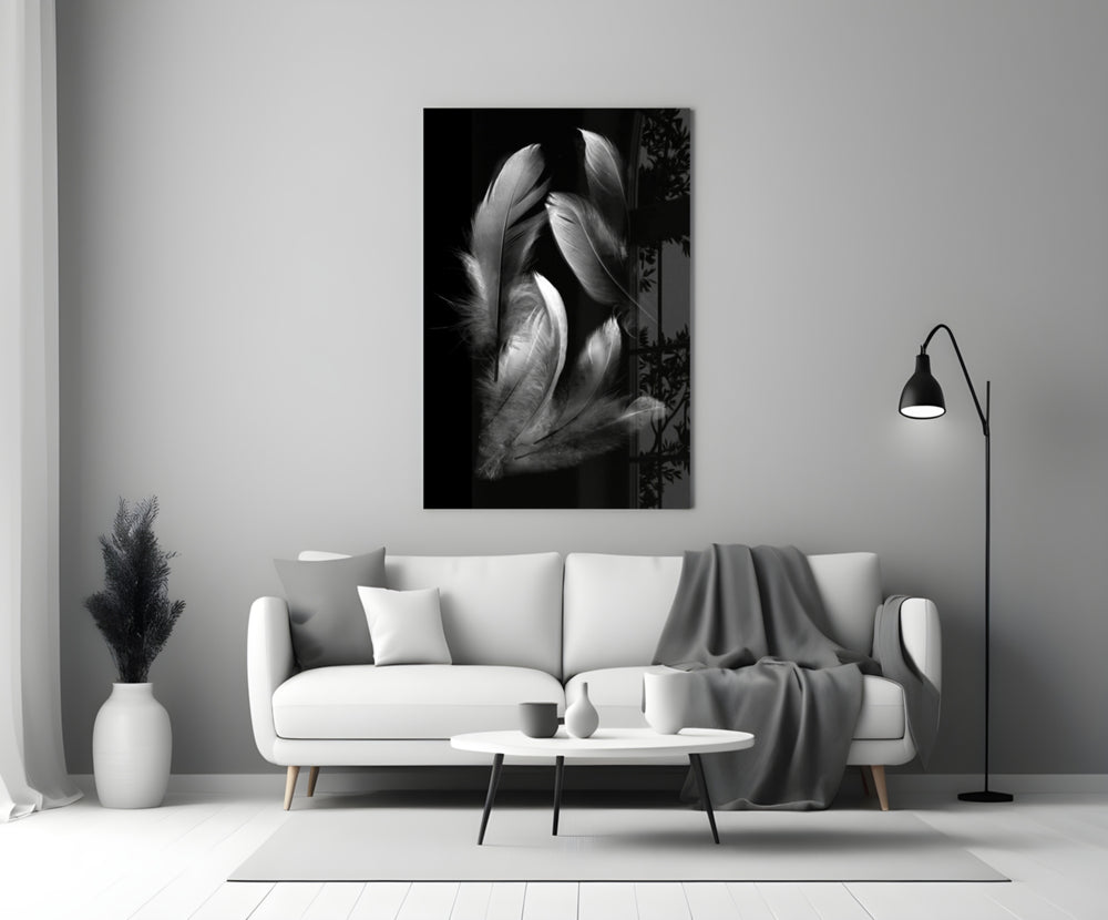 Feather glass wall art styled above a bed in a bedroom